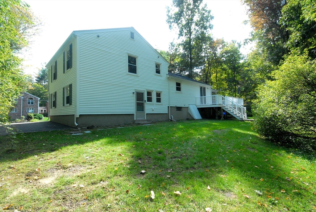 13 Beverly Road Acton, MA 01720 - Photo 21 of 23 a view of backyard with barbeque grill potted plants and large trees