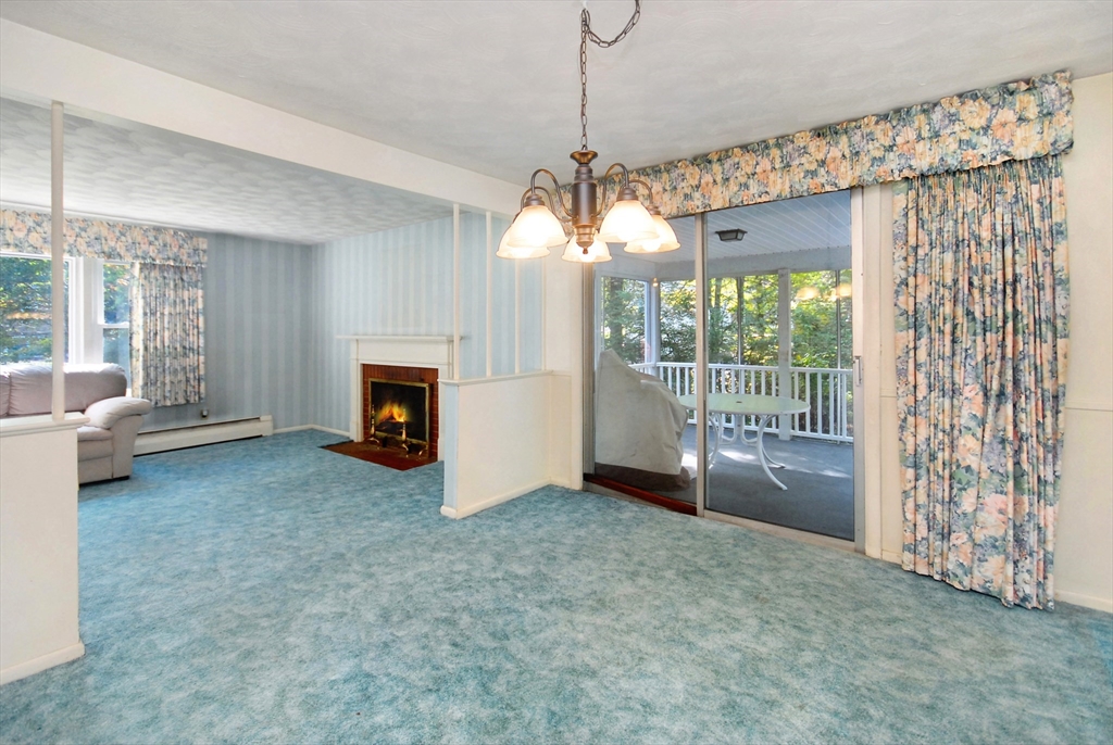 13 Beverly Road Acton, MA 01720 - Photo 8 of 23 a view of an empty room with a fireplace and a window
