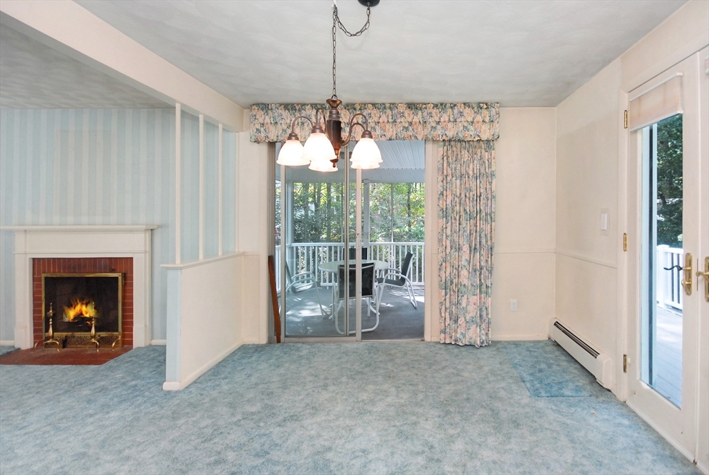 13 Beverly Road Acton, MA 01720 - Photo 9 of 23 a view of an empty room with fireplace and a window