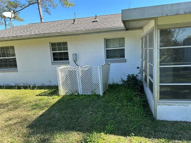a backyard of a house with lots of green space and plants