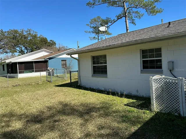 a backyard of a house with table and chairs