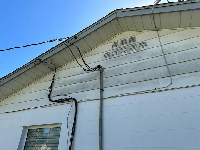 a roof deck with table and chairs