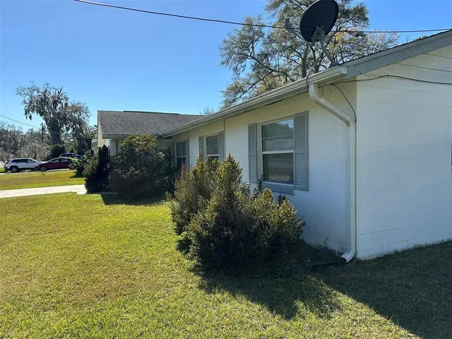 a backyard of a house with yard and outdoor seating