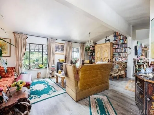 a living room with furniture and a book shelf