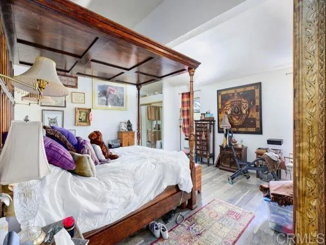 a bedroom with a bed a couch and dresser