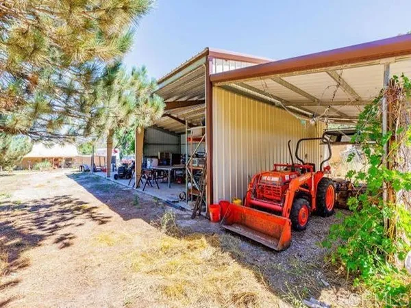 a view of a backyard with a table and chairs