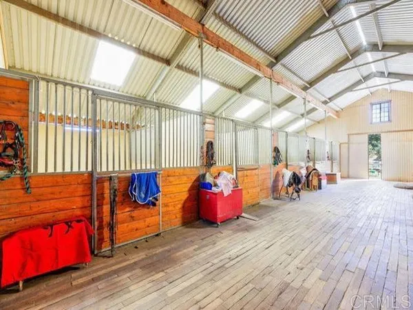 a view of a room with wooden floor and furniture