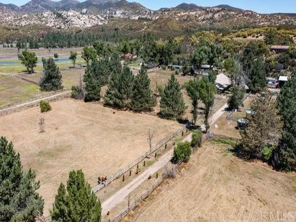 a view of a dry yard with mountains in the background