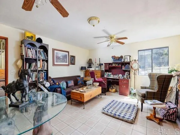 a living room with furniture and a bookshelf