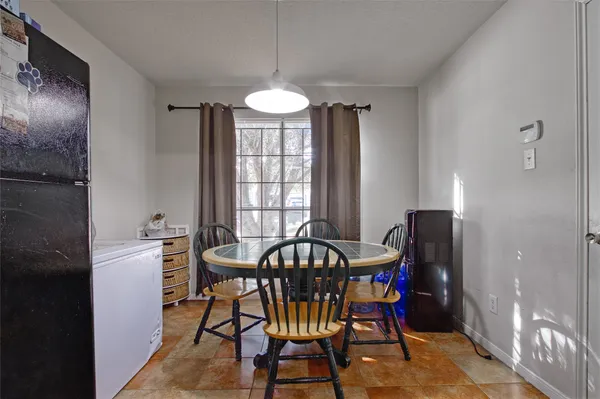 a view of a dining room with furniture and a chandelier