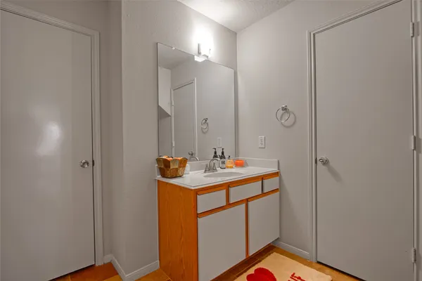 a bathroom with a sink a mirror and a shower