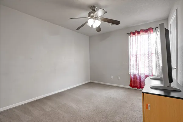 a view of a room with window chandelier fan and windows