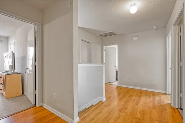 a view of a room with wooden floor and cabinet