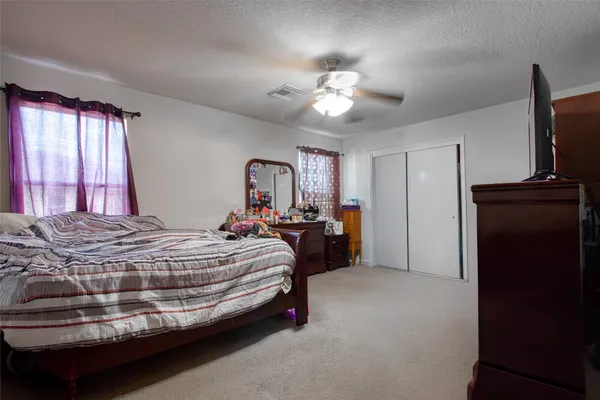 a bed room with a bed and a television