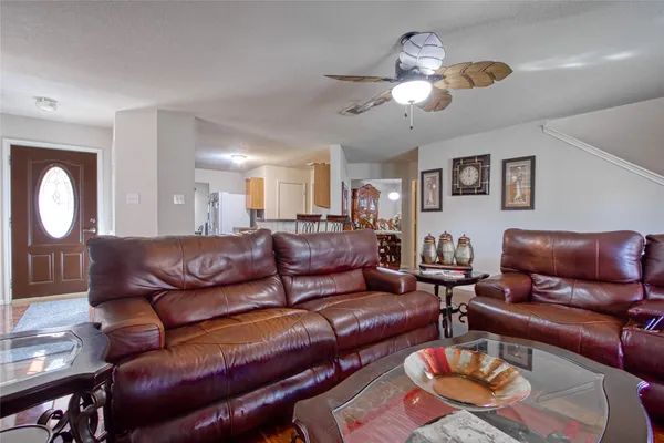 a living room with furniture and a chandelier