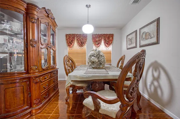 a view of a dining room with furniture and chandelier