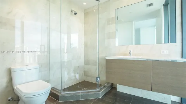 a bathroom with a shower and a toilet