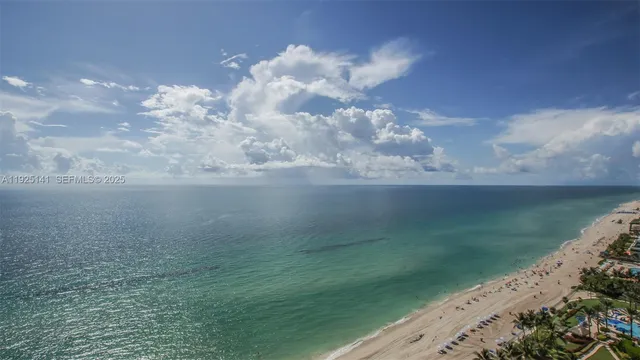 a white toilet sitting next to a white sink