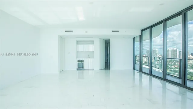 a view of an empty room with windows