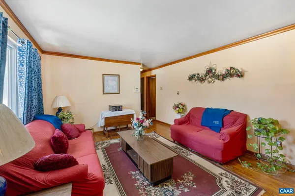 a living room with furniture rug and a window