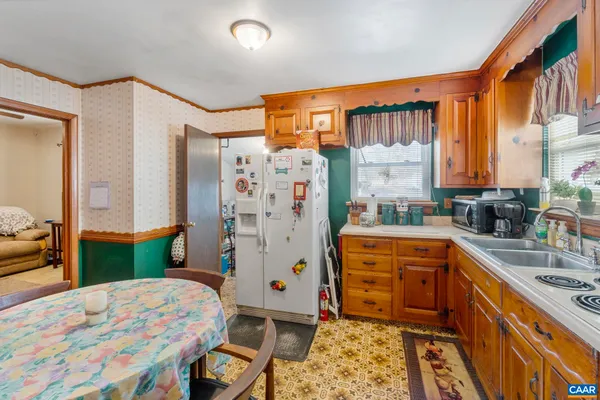 a kitchen with stainless steel appliances granite countertop a refrigerator a stove and a sink with dishwasher
