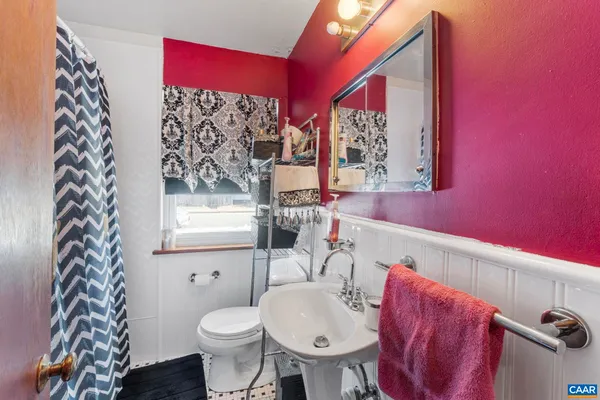 a bathroom with a toilet sink and mirror