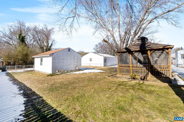 a view of a house with a yard covered in snow