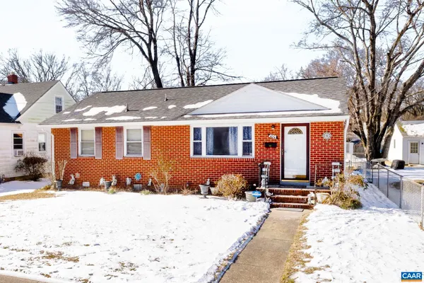 a front view of a house with a yard covered in snow