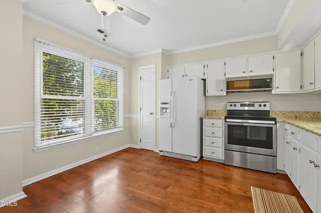 a kitchen with stainless steel appliances a stove sink and microwave