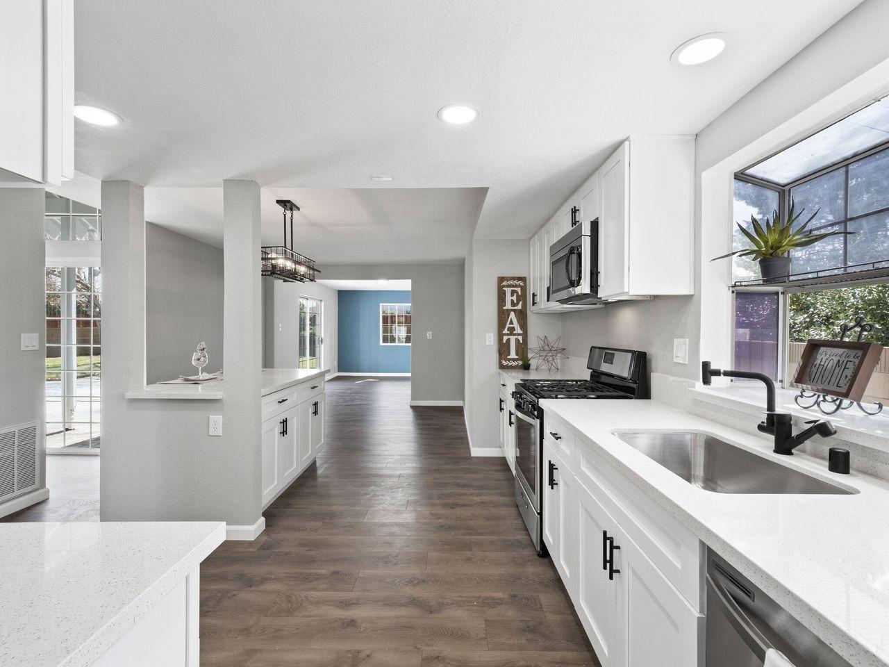 6002 Caleche Road Lancaster, CA 93536 - Photo 8 of 31 a kitchen with white cabinets appliances and sink
