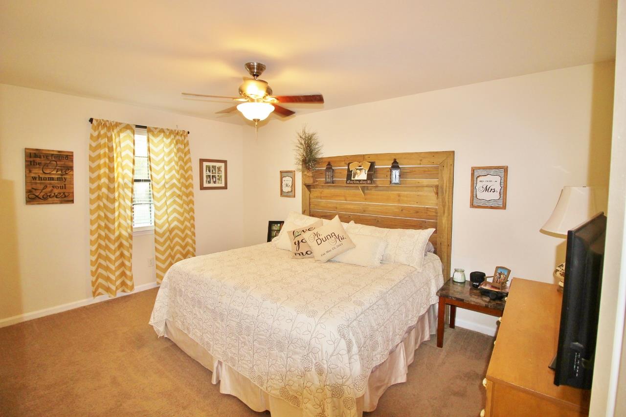 3975 Beasleys Bend Road Lebanon, TN 37087 - Photo 11 of 25 a bedroom with a bed and a chandelier