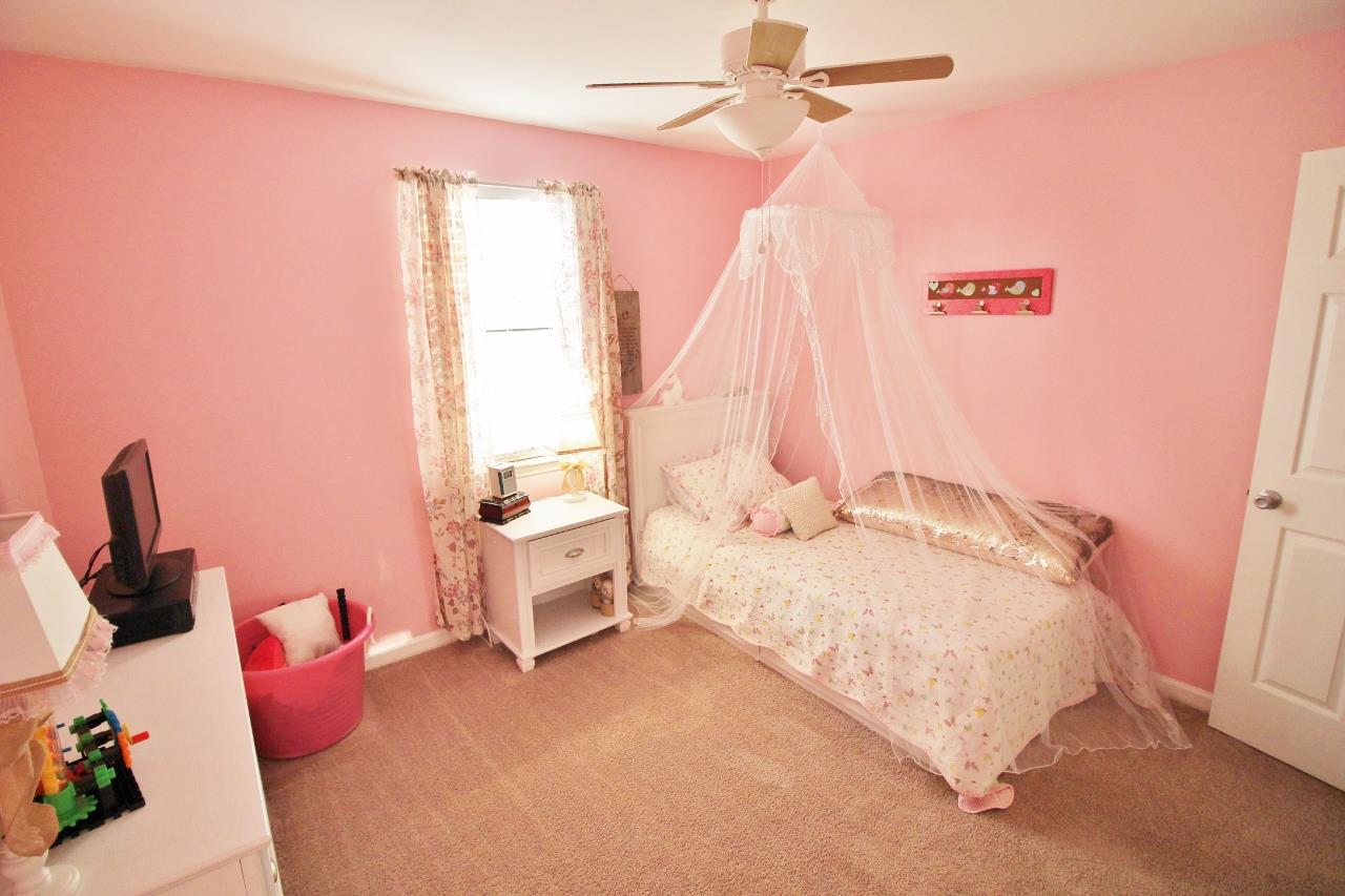 3975 Beasleys Bend Road Lebanon, TN 37087 - Photo 19 of 25 a bedroom with a bed and a chandelier