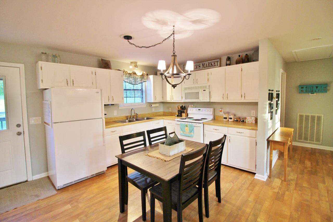 3975 Beasleys Bend Road Lebanon, TN 37087 - Photo 9 of 25 a kitchen with refrigerator cabinets dining table and chairs