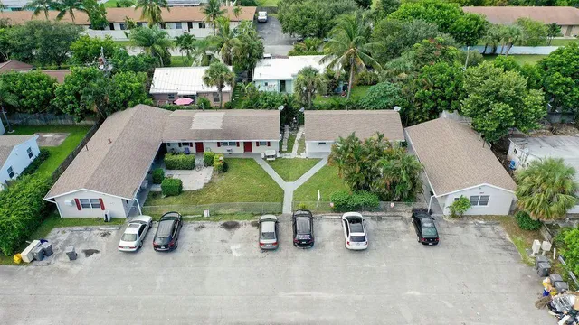 an aerial view of a house with garden space and street view