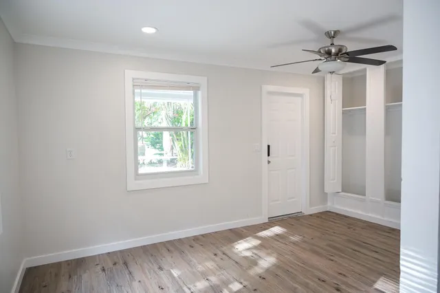 wooden floor in an empty room with a window