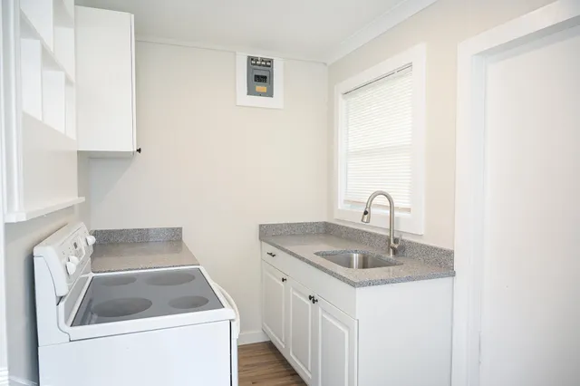 a kitchen that has a sink and a stove