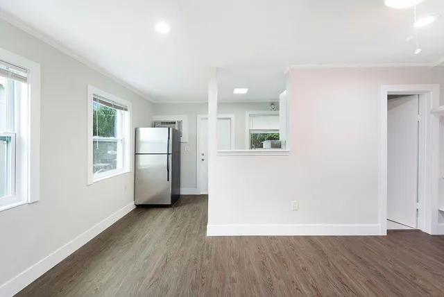 an empty room with windows and closet