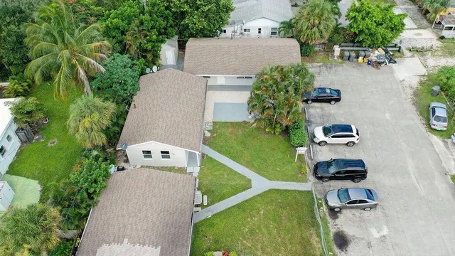 an aerial view of a house with garden space and street view