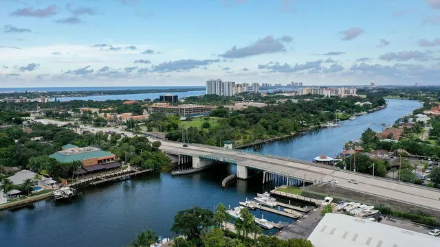 an aerial view of a city with lots of residential buildings lake and ocean view