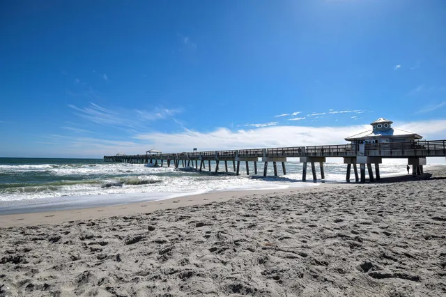 a view of a roof deck with wooden floor and fence