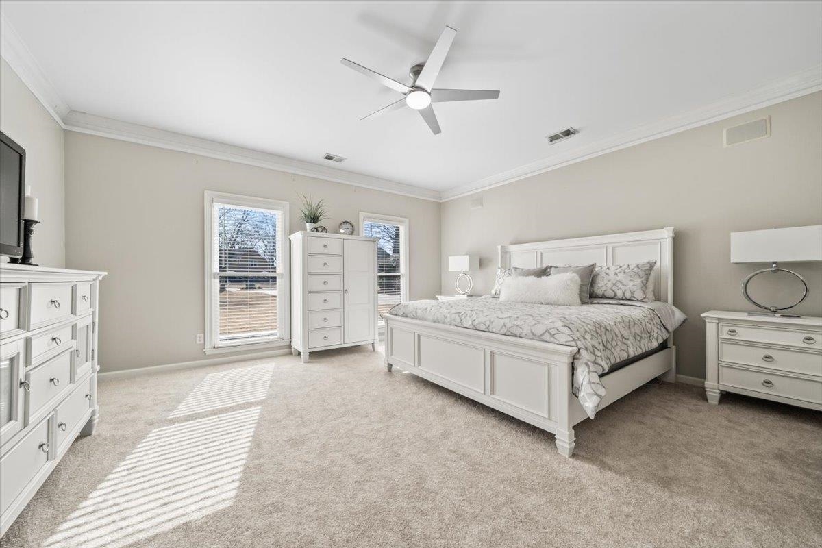 1804 Lisson Lane Collierville, TN 38017 - Photo 16 of 35 a bedroom with a large bed and a chandelier