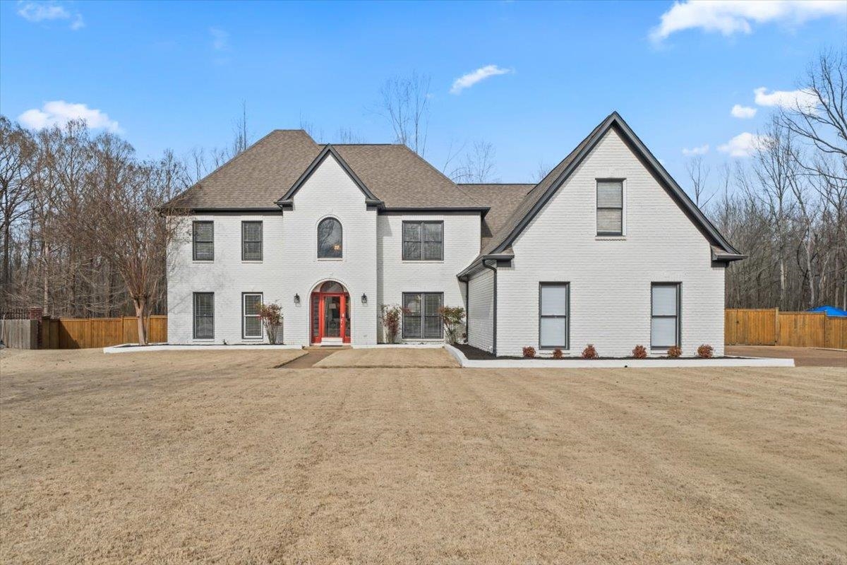 1804 Lisson Lane Collierville, TN 38017 - Photo 4 of 35 a view of a white house with a yard and large trees