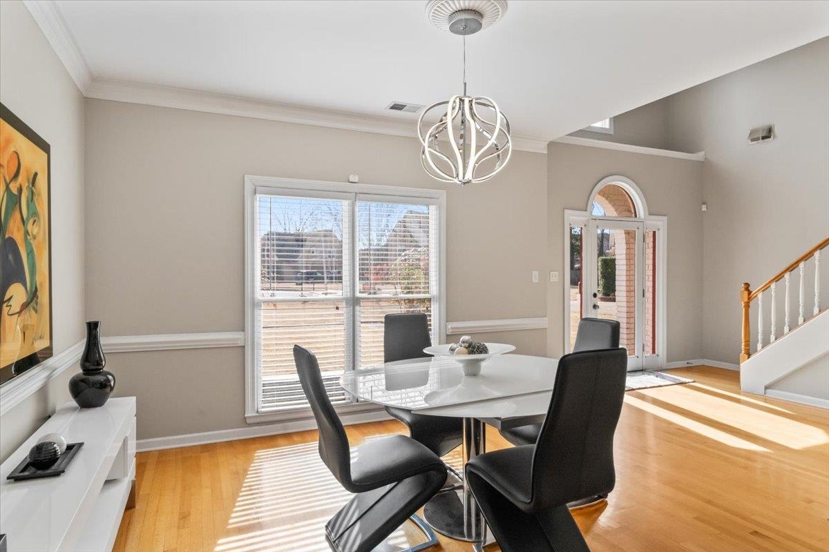 1804 Lisson Lane Collierville, TN 38017 - Photo 8 of 35 a view of a dining room with furniture wooden floor and chandelier