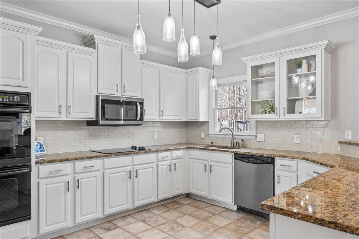 1804 Lisson Lane Collierville, TN 38017 - Photo 10 of 35 a kitchen with a sink white cabinets and white appliances