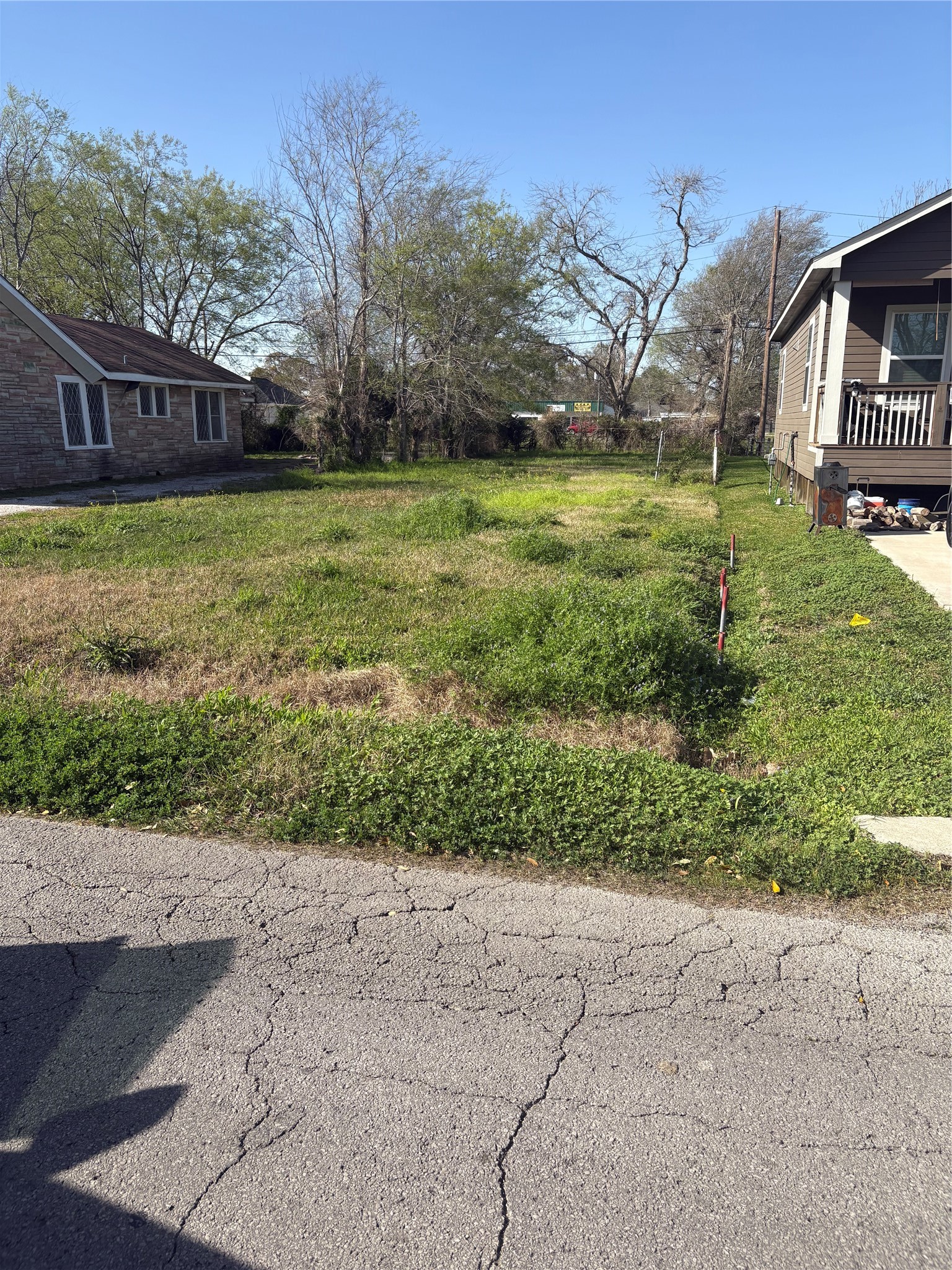 a view of a street with a yard and a fountain