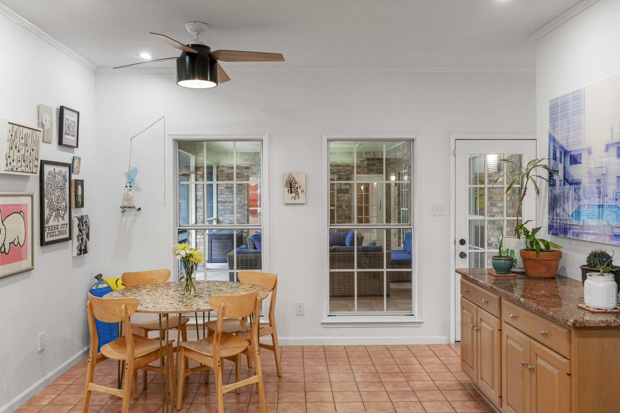 400 Hackberry Street Lockhart, TX 78644 - Photo 17 of 40 Sun-drenched breakfast nook with a charming dining set and tiled floors, offering views to a cozy outdoor seating area.