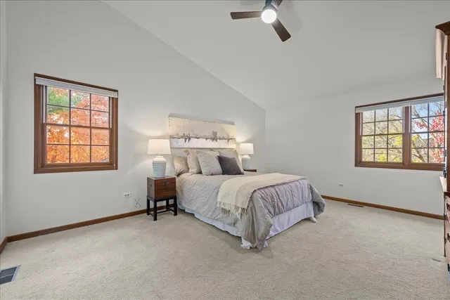 a spacious bedroom with a bed and window