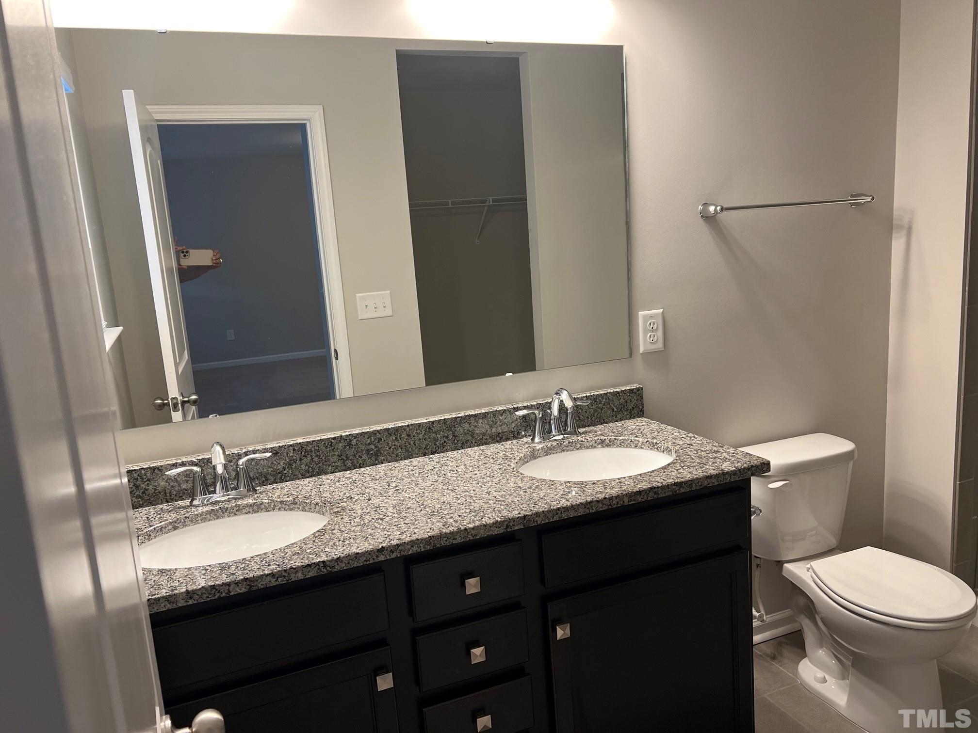 562 Metro Station Apex, NC 27502 - Photo 12 of 19 a bathroom with a granite countertop sink and a mirror