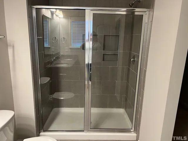 a bathroom with a glass shower door