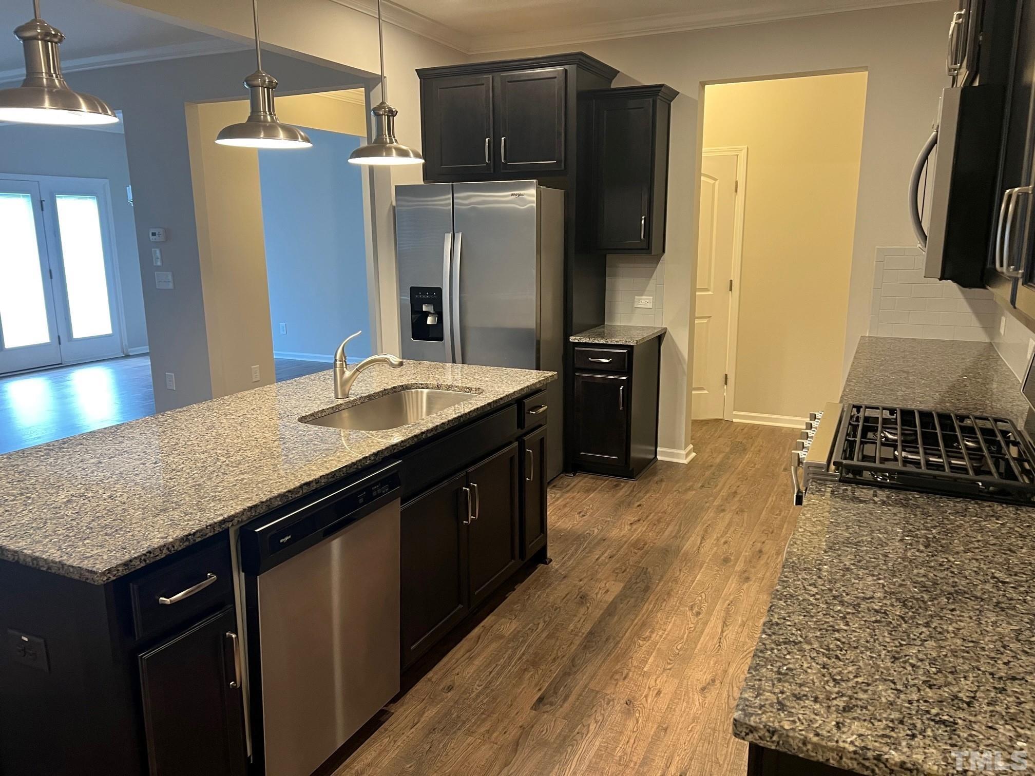 562 Metro Station Apex, NC 27502 - Photo 5 of 19 a kitchen with stainless steel appliances granite countertop a sink stove and refrigerator